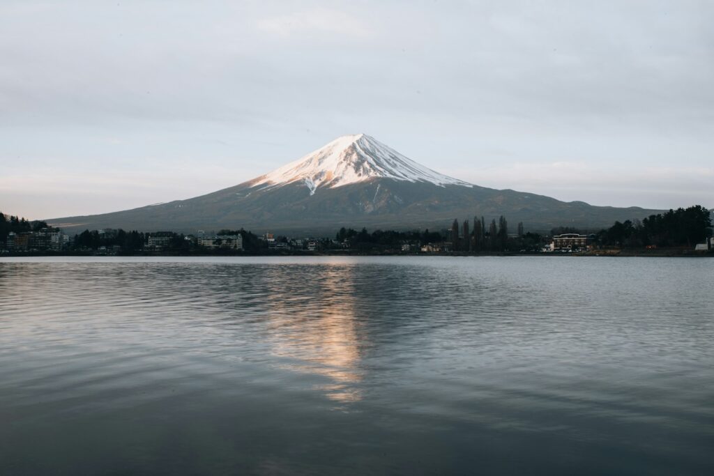 white and black mountain near body of water during daytime