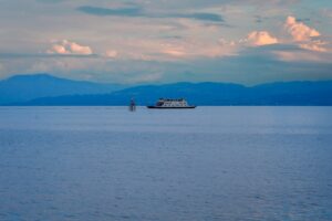 A large boat floating on top of a large body of water